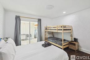 Desoto house for rent - A bedroom with a bunk bed and a white bedspread.