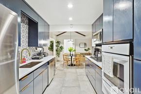 Desoto house for rent - A modern kitchen with stainless steel appliances and a dining area with a table and chairs.