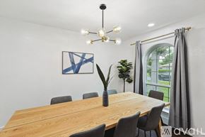 Desoto house for rent - A dining room with a wooden table and chairs.