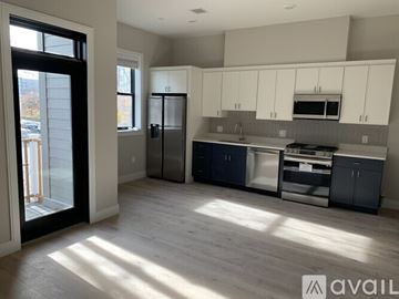 Boston apartment for rent - A kitchen with white cabinets and a black refrigerator.