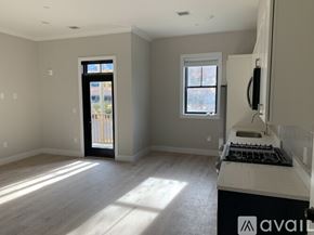 Boston apartment for rent - A kitchen with a window and a door leading outside.