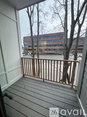 Boston apartment for rent - A balcony with a view of a river and buildings.