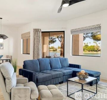 Scottsdale condo for rent - A living room with a blue couch and a coffee table.