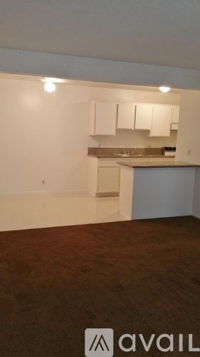 Bakersfield apartment for rent - A kitchen area with a refrigerator, sink, and countertop.