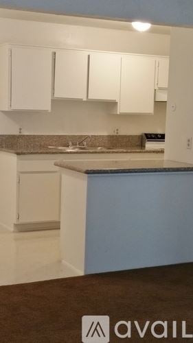 Bakersfield apartment for rent - A white bathroom with a tub and a shower.