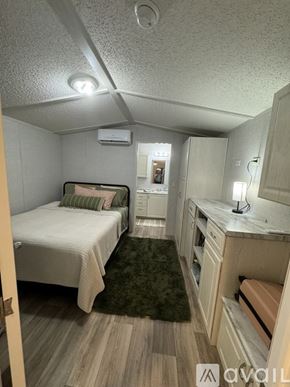 Horse Cave house for rent - A small bedroom with a bed, a desk, and a chair.