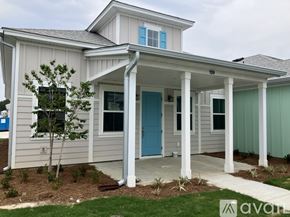 Hardeeville house for rent - A house with a blue door and a porch.