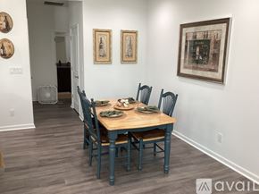 Hardeeville house for rent - A dining room with a wooden table and chairs.