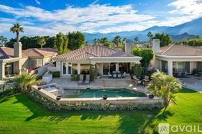 La Quinta house for rent - A large house with a pool in the backyard.