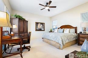 La Quinta house for rent - A bedroom with a bed, desk, and chair.