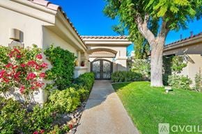 La Quinta house for rent - A house with a tree in front and a pathway leading to the entrance.