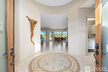 La Quinta house for rent - A large, open living room with a rug in the middle and a sculpture on the wall.