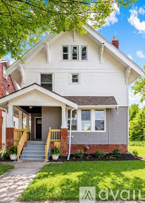 Detroit house for rent - A two-story house with a front porch and a tree in front.