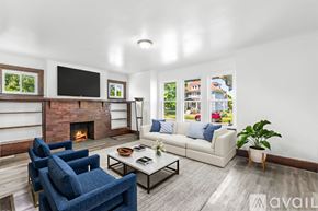 Detroit house for rent - A room with wooden floors and white walls, with a window and a door visible.
