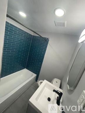 Blackwood apartment for rent - A bathroom with a white sink and a white bathtub.