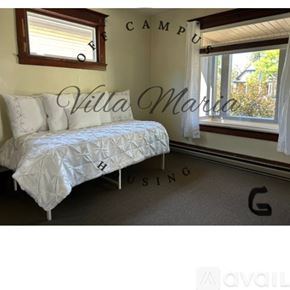 Spokane apartment for rent - A bedroom with a bed, window, and a sign that says "Villa Martin".