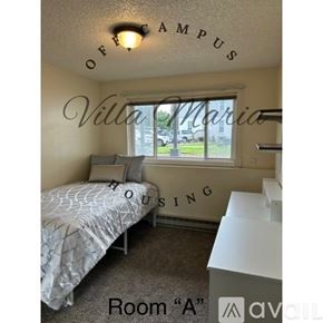 Spokane apartment for rent - A bedroom with a bed, dresser and window with Villa Maria on the wall.