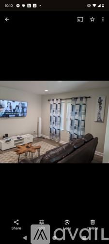 Tuskegee house for rent - A living room with a brown leather couch and a wooden coffee table.