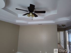 Edinburg apartment for rent - A room with a ceiling fan and a wall with a logo on it.