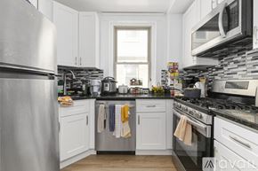 Cambridge apartment for rent - A kitchen with white cabinets and a stainless steel refrigerator.