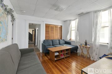 Cambridge apartment for rent - A living room with a grey couch and a blue sofa.