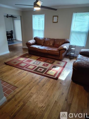 Anderson house for rent - A living room with a brown leather couch and a rug.