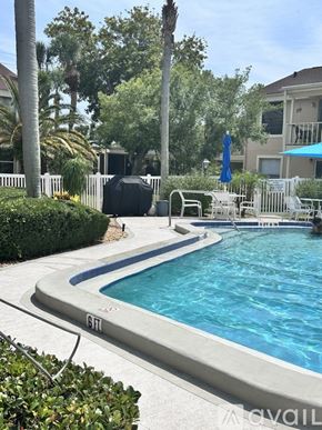Bradenton condo for rent - A pool with a slide and a sun lounger.