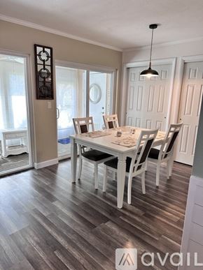 Bradenton condo for rent - A dining room with a table set for four.