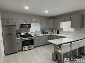 Blythe apartment for rent - A modern kitchen with stainless steel appliances and a central island.