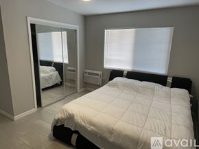 Blythe apartment for rent - A bedroom with a large bed and a mirror on the wall.