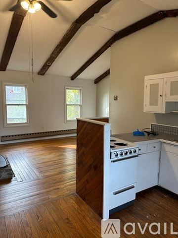 Oswego apartment for rent - A kitchen with wooden floors and white appliances.