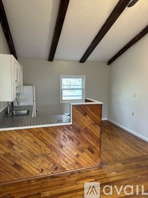 Oswego apartment for rent - A room with wooden flooring and a window.