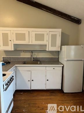 Oswego apartment for rent - A kitchen with white appliances and cabinets.