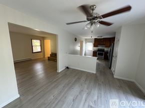 State College house for rent - A room with a ceiling fan and wooden flooring.