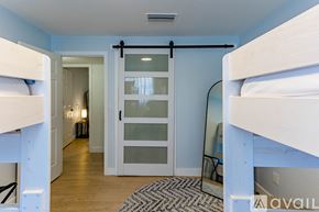 Lake Havasu City house for rent - A bedroom with a white bunk bed and a mirror on the wall.