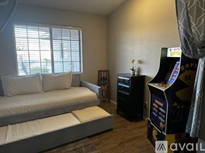 Lake Havasu City house for rent - A room with a couch, a small table, and a gaming console.