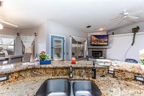 Lake Havasu City house for rent - A kitchen with a stone counter top and a sink.