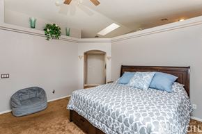 Lake Havasu City house for rent - A bedroom with a large bed and a grey dog bed.