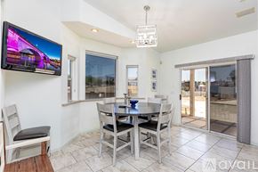Lake Havasu City house for rent - A modern dining room with a television mounted on the wall.