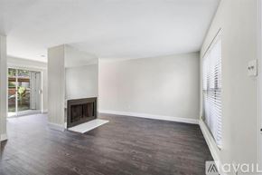 Houston apartment for rent - A spacious living room with a fireplace and wooden flooring.