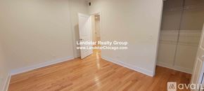 Chicago apartment for rent - A room with wooden flooring and white walls, with a doorway leading to another room.