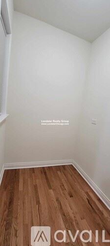 Chicago apartment for rent - A room with wooden flooring and white walls.