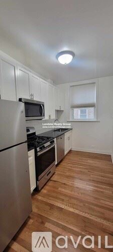 Chicago apartment for rent - A kitchen with wooden floors and stainless steel appliances.