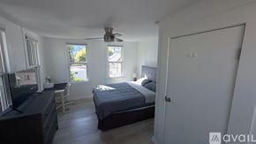 San Diego apartment for rent - A bedroom with a bed, desk, and window.
