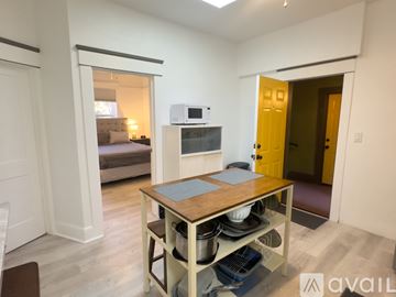 San Diego apartment for rent - A kitchen area with a table and a microwave on top of a cabinet.