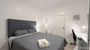 San Diego apartment for rent - A bedroom with a large bed and a desk with a chair.