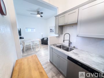 San Diego apartment for rent - A kitchen with a wooden table and a sink.