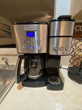 Lecanto townhouse for rent - A coffee maker with a digital display and a water filter is on a kitchen counter.