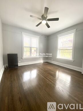 Chicago apartment for rent - A room with wooden floors and a ceiling fan.