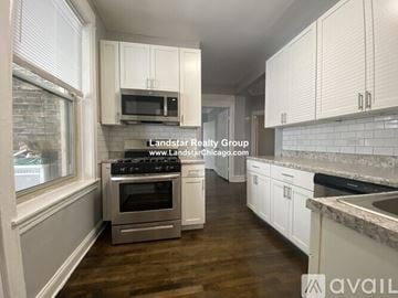 Chicago apartment for rent - A kitchen with white cabinets and a stainless steel oven.